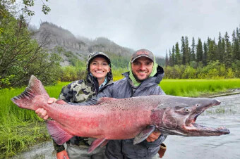 Guests holding a large king salmon caught on the Copper River